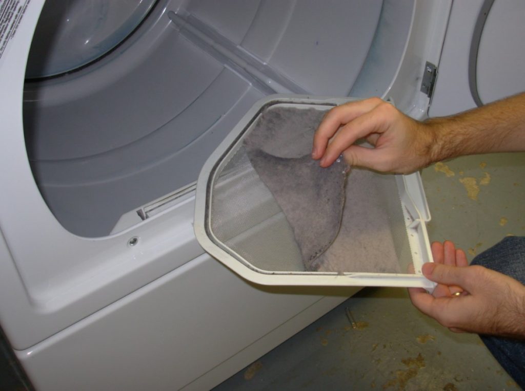 Dryer vent cleaning with a hand cleaning lint from the dryer lint screen