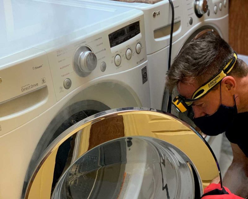Washer being cleaned and sanitized by technician
