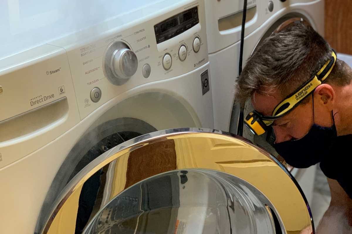 Washer being cleaned and sanitized by technician